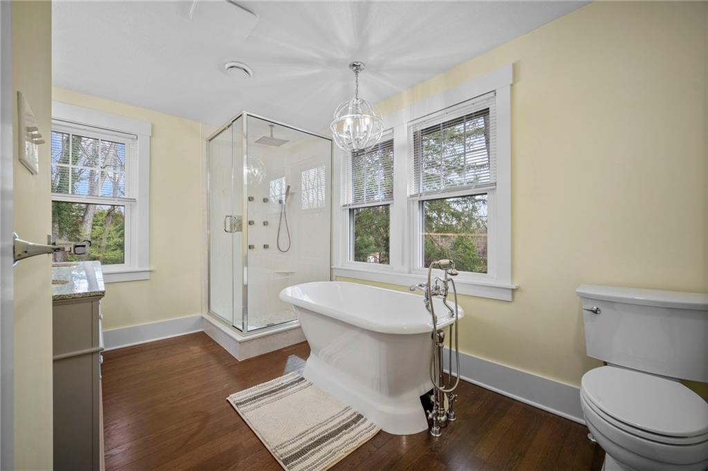 3252 Comanche Road Upper St. Clair, PA 15241 - Photo 23 of 50 a bathroom with a granite countertop sink toilet a mirror and shower