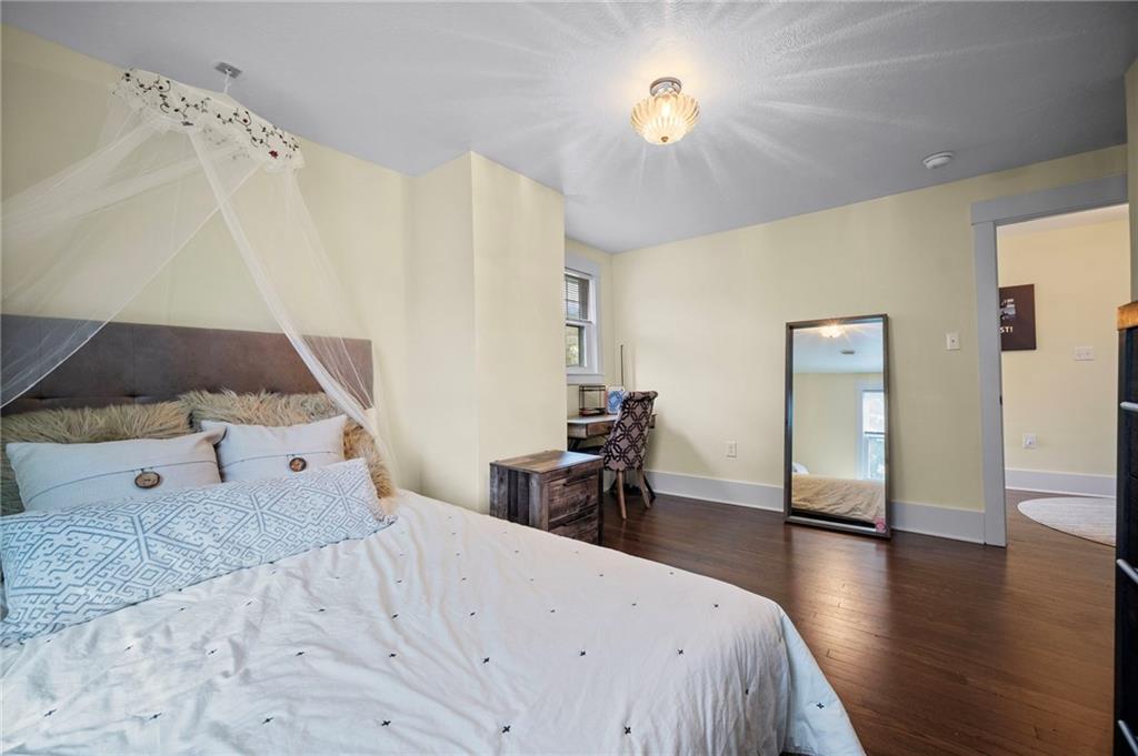 3252 Comanche Road Upper St. Clair, PA 15241 - Photo 27 of 50 a spacious bedroom with a bed and a chandelier