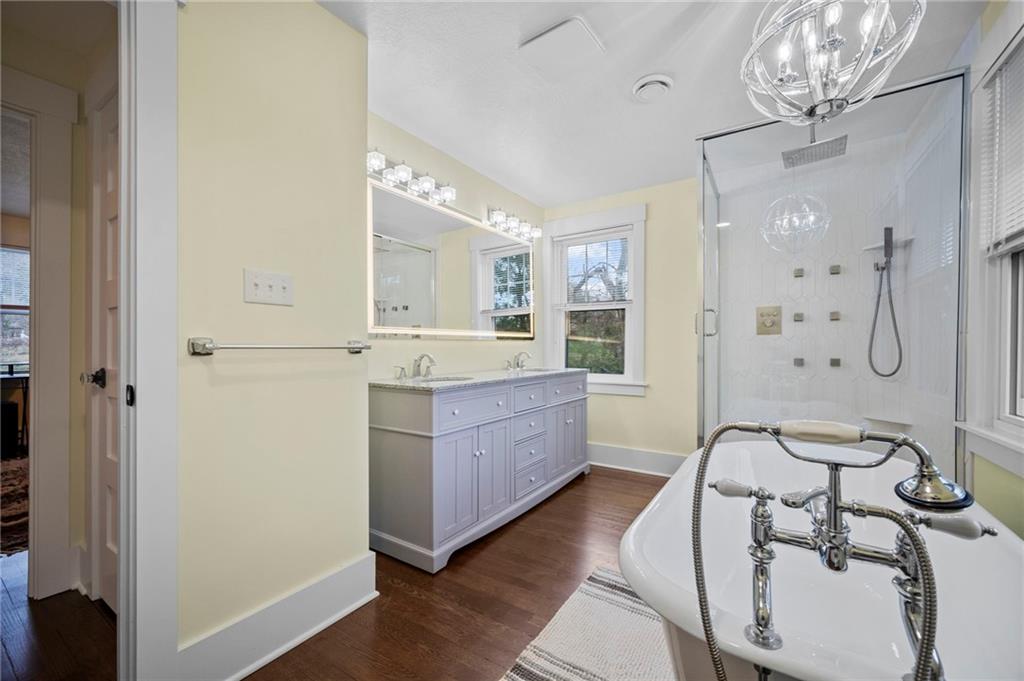 3252 Comanche Road Upper St. Clair, PA 15241 - Photo 28 of 50 a bathroom with a double vanity sink a mirror and a bathtub