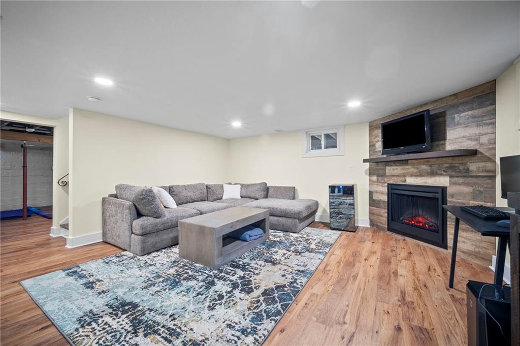 3252 Comanche Road Upper St. Clair, PA 15241 - Photo 33 of 50 a living room with furniture a fireplace and a flat screen tv