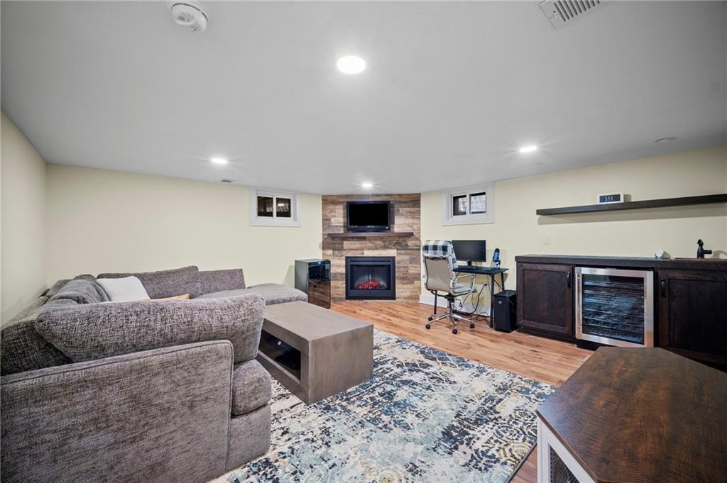 3252 Comanche Road Upper St. Clair, PA 15241 - Photo 37 of 50 a living room with furniture a fireplace and a flat screen tv