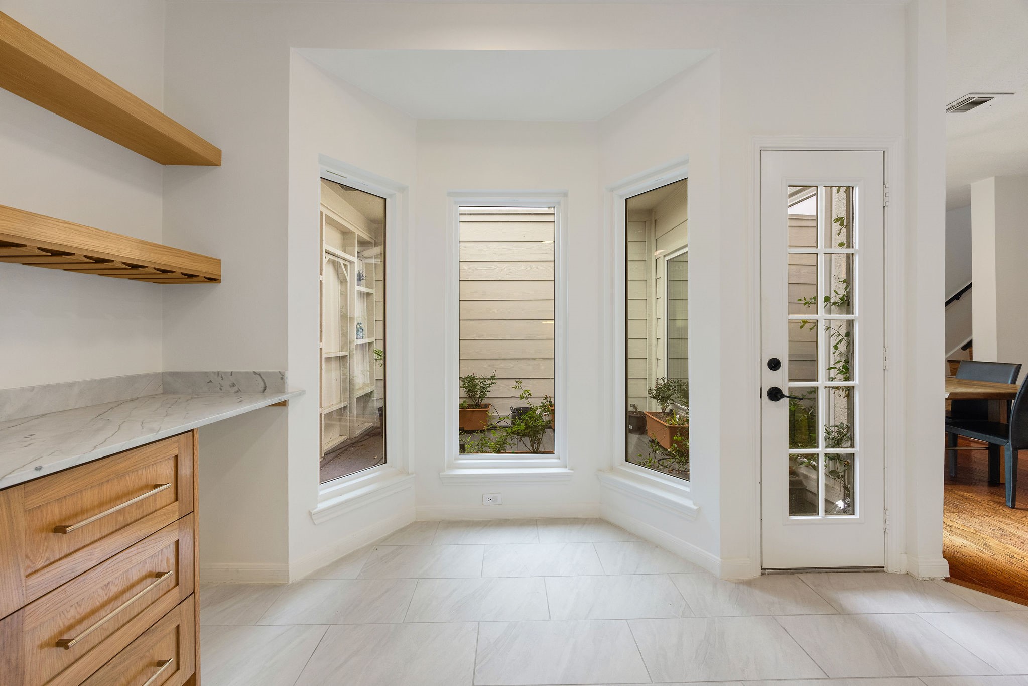 727 Bunker Hill Road, Unit 26 Houston, TX 77024 - Photo 10 of 25 The breakfast nook is a perfect for your morning coffee. The built-in shelves are perfect for holding wine glasses, other kitchenware. The drawers are also a great space to place your keys and mail, as the garage entrance is to the left.