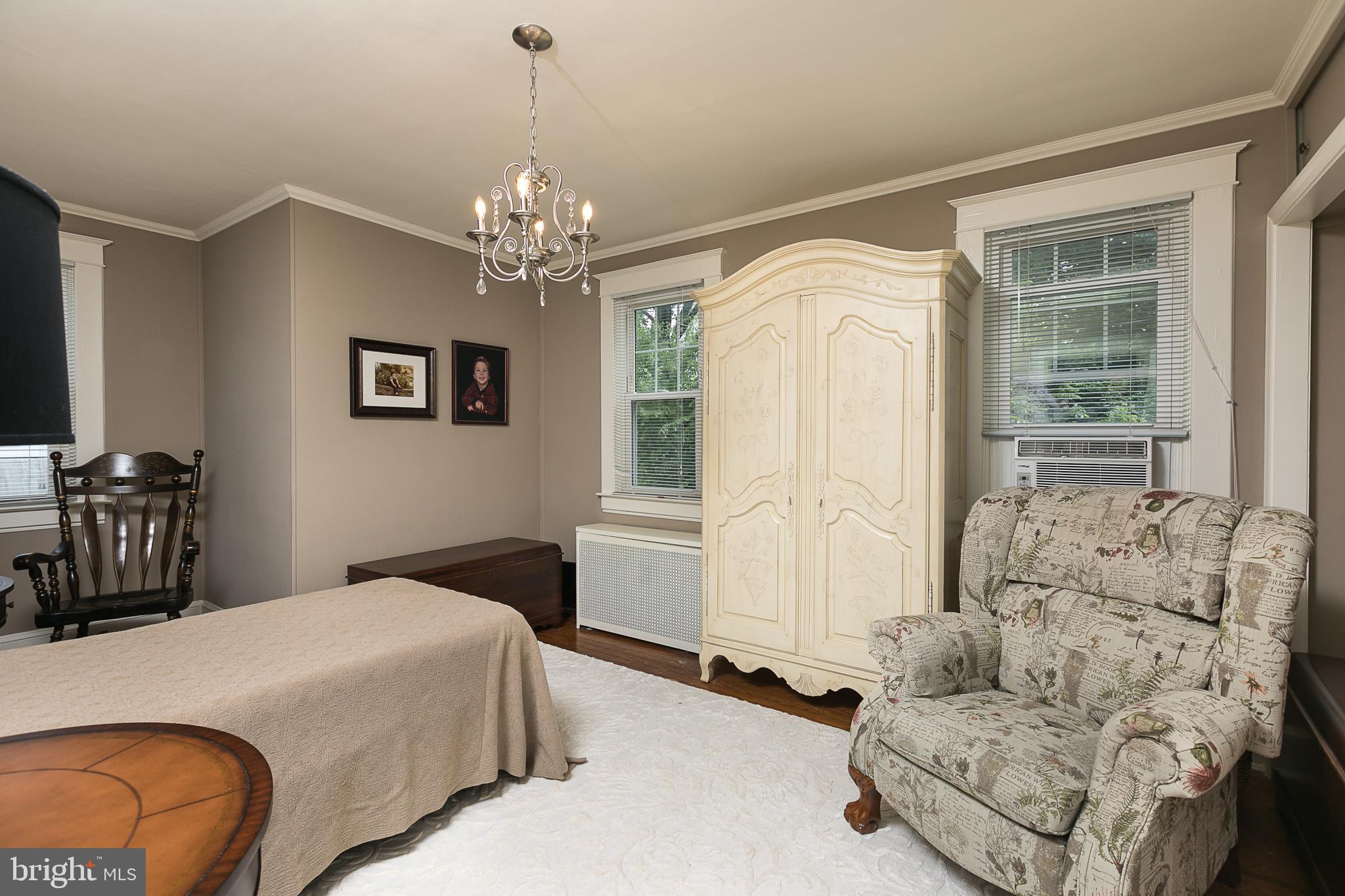 425 Westgate Road Baltimore, MD 21229 - Photo 20 of 32 a bed room with a bed and a chandelier