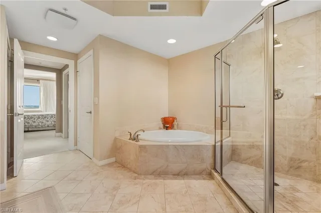 a bathroom with a tub and shower