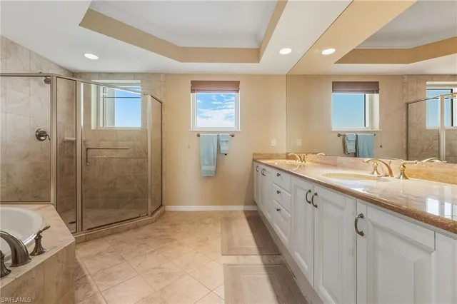 a spacious bathroom with a mirror a shower and a sink