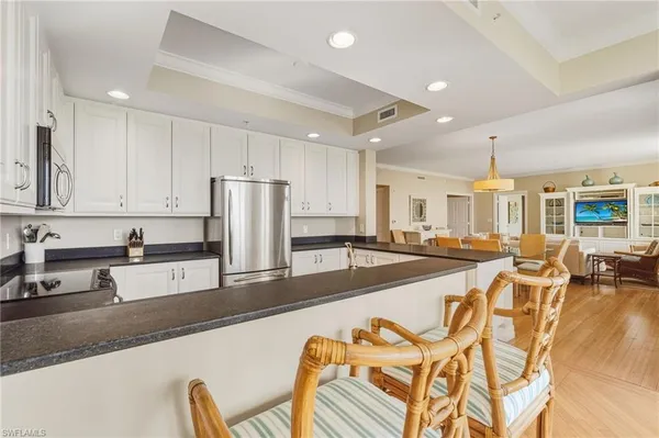 a large kitchen with lots of counter top space and stainless steel appliances