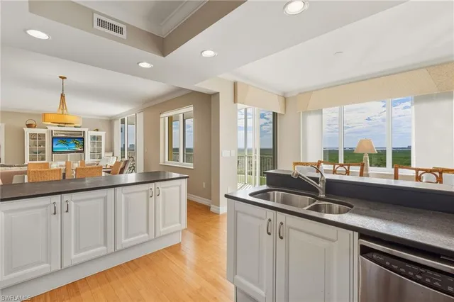 a kitchen with sink and large window