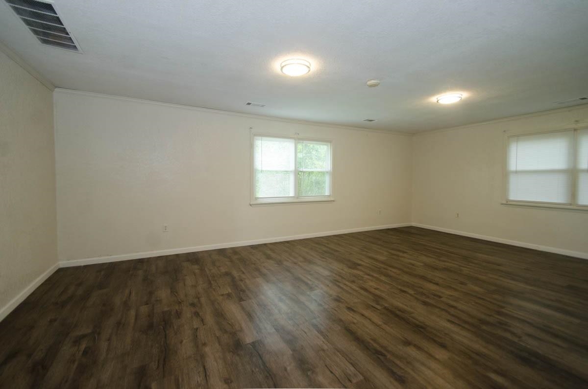 35 Dee Road Somerville, TN 38068 - Photo 11 of 15 Empty room with ornamental molding and dark wood-style flooring
