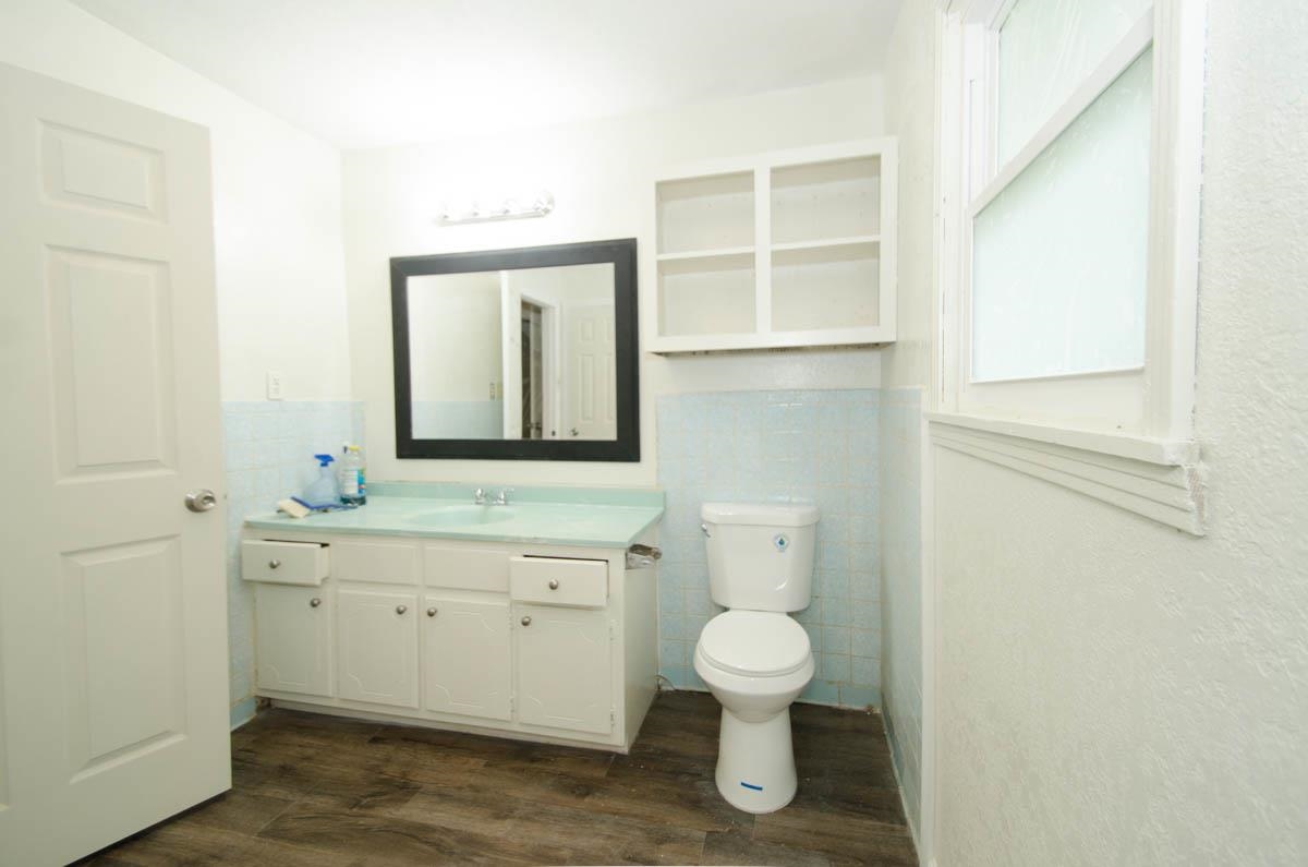 35 Dee Road Somerville, TN 38068 - Photo 13 of 15 Bathroom with wood finished floors, tile walls, vanity, and a wainscoted wall