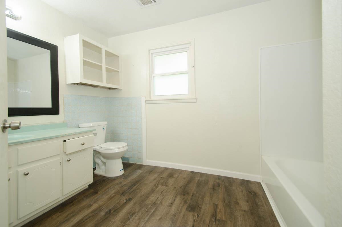 35 Dee Road Somerville, TN 38068 - Photo 14 of 15 Bathroom featuring wood finished floors, vanity, and tile walls