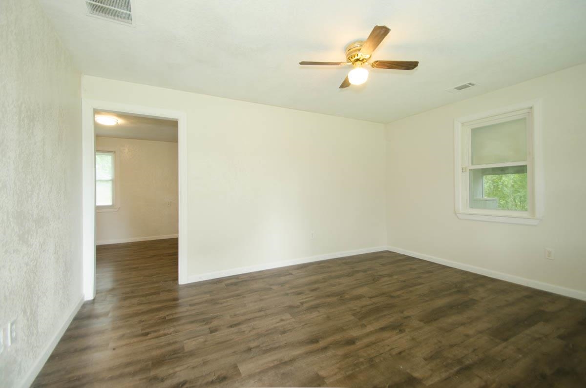 35 Dee Road Somerville, TN 38068 - Photo 4 of 15 Unfurnished room with a ceiling fan and dark wood finished floors