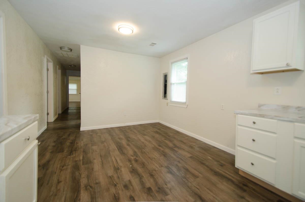 35 Dee Road Somerville, TN 38068 - Photo 6 of 15 Unfurnished dining area with dark wood-style flooring and baseboards