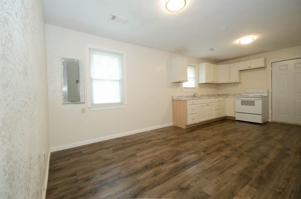 35 Dee Road Somerville, TN 38068 - Photo 7 of 15 Kitchen featuring electric range, dark wood-style floors, healthy amount of natural light, and light countertops