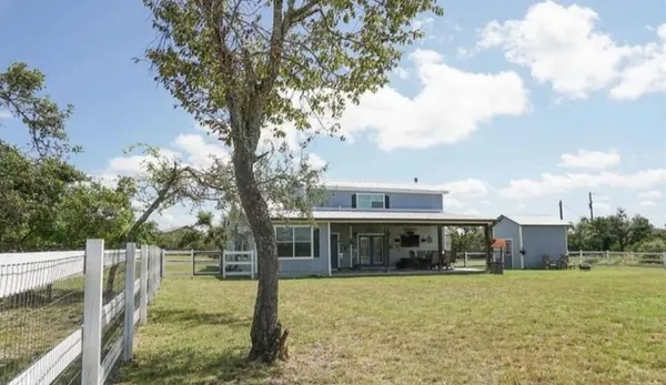 a front view of house with yard space and seating