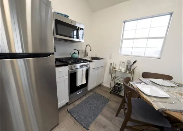 a kitchen with stainless steel appliances a stove a sink and a refrigerator