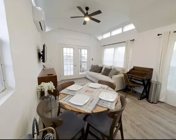 a living room with furniture a chandelier and a coffee table