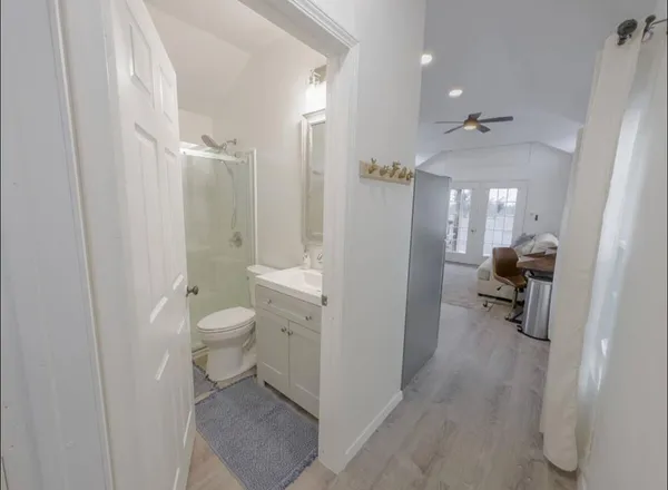a bathroom with a sink a toilet and a shower