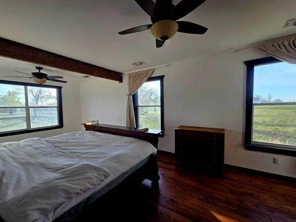 a bedroom with a bed and a window
