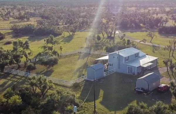 an aerial view of residential houses with outdoor space