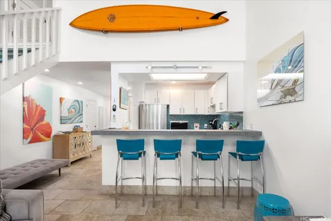 a kitchen with stainless steel appliances kitchen island granite countertop a table and chairs