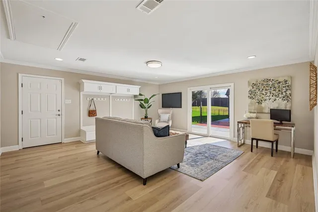 a living room with furniture and a wooden floor
