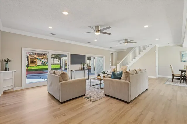 a living room with furniture dining table and wooden floor