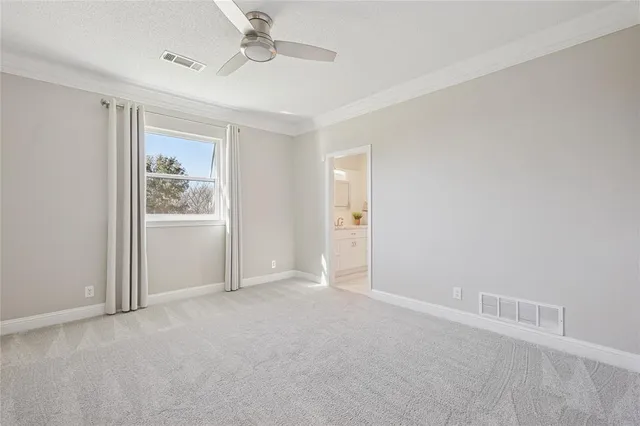 a bathroom with a granite countertop sink vanity mirror and toilet