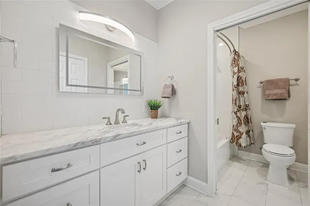 a bathroom with a granite countertop sink mirror and vanity