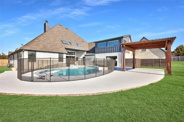 a view of a house with a big yard and large trees