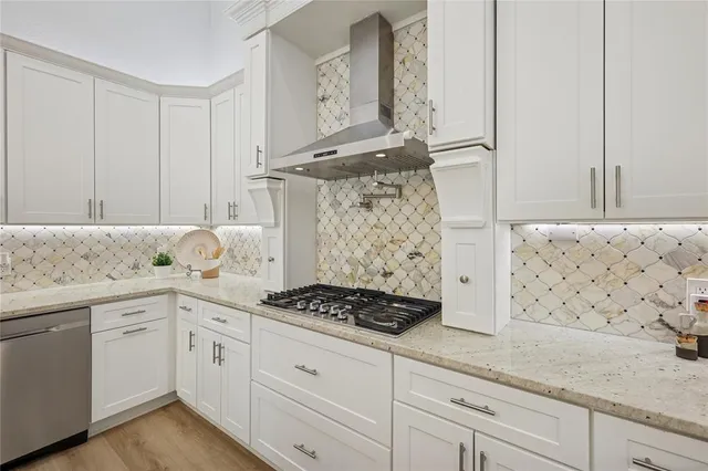 a kitchen with granite countertop white cabinets and white appliances