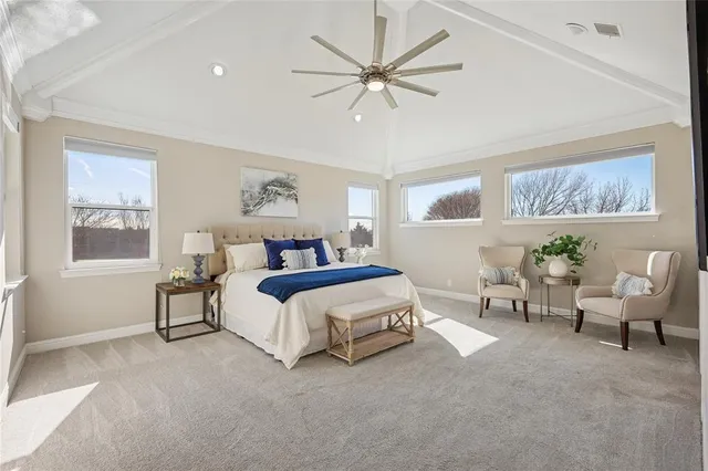 a spacious bedroom with a large bed and a window