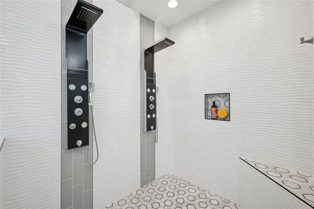 a bathroom with a painting on the wall and shower