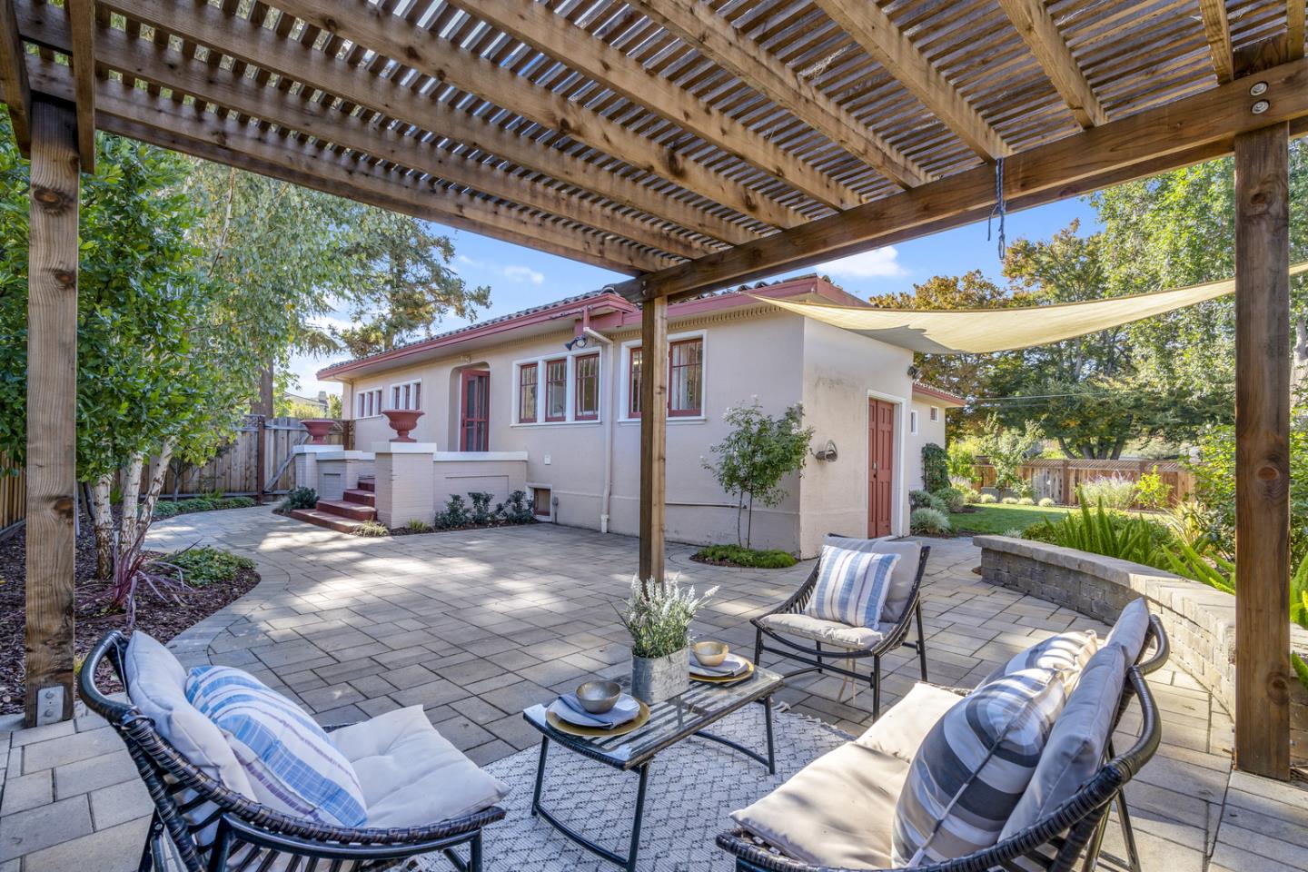 a view of a patio with furniture and a backyard