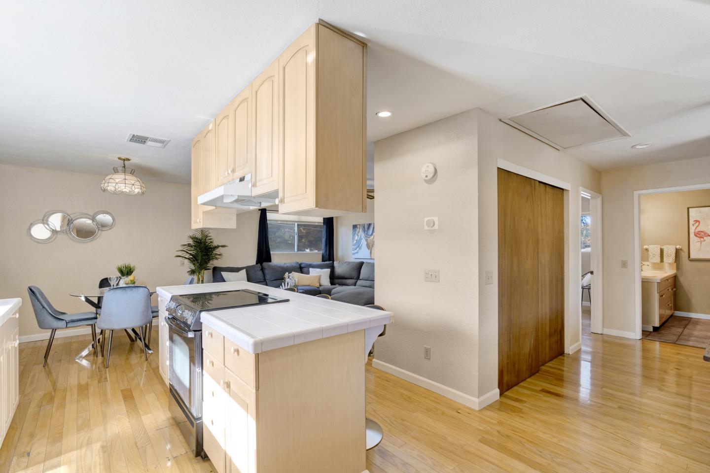445 Northern Road San Jose, CA 95125 - Photo 32 of 42 a living room with stainless steel appliances kitchen island granite countertop a refrigerator a sink a stove and white cabinets with wooden floor