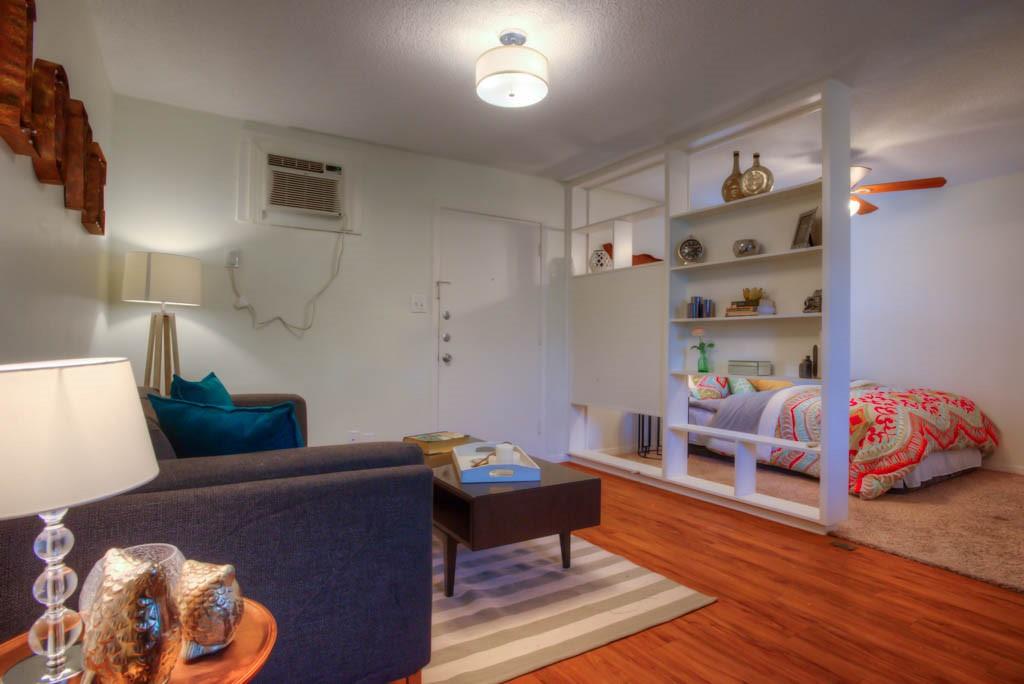 302 East 34th Street, Unit 103 Austin, TX 78705 - Photo 3 of 6 a living room with furniture and a wooden floor