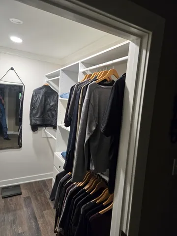 a utility room with lots of different colored cloths