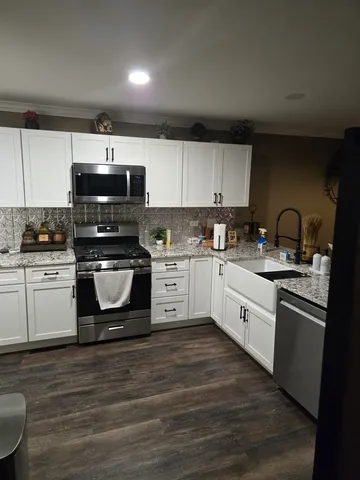 a bedroom with a bed and a night stand