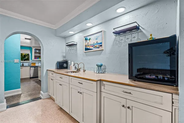 a kitchen with stainless steel appliances white cabinets and a sink