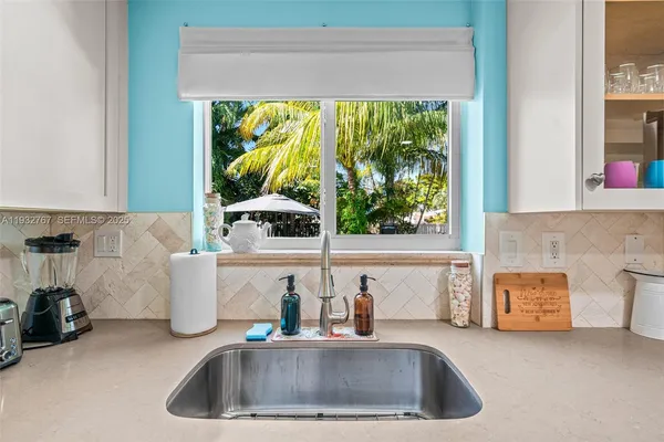 a kitchen with a refrigerator and a sink