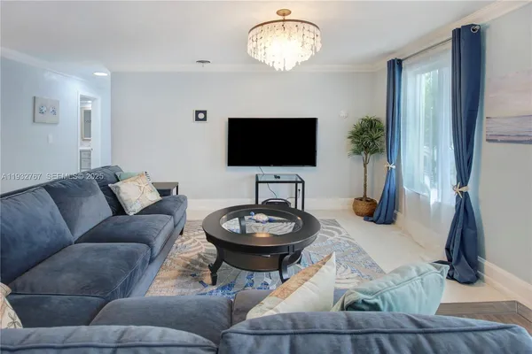a living room with furniture and a flat screen tv