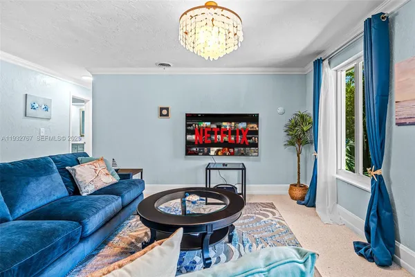 a living room with furniture and a flat screen tv