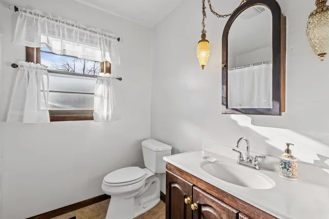 a bathroom with a sink a toilet and mirror