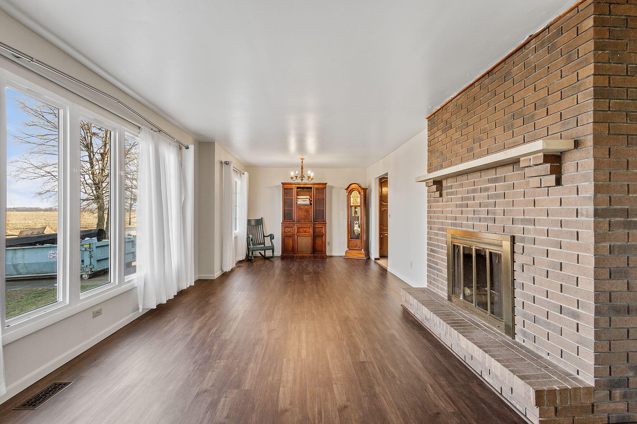 6801 West 1350th Street North Demotte, IN 46310 - Photo 5 of 44 a view of a livingroom with wooden floor and a fireplace