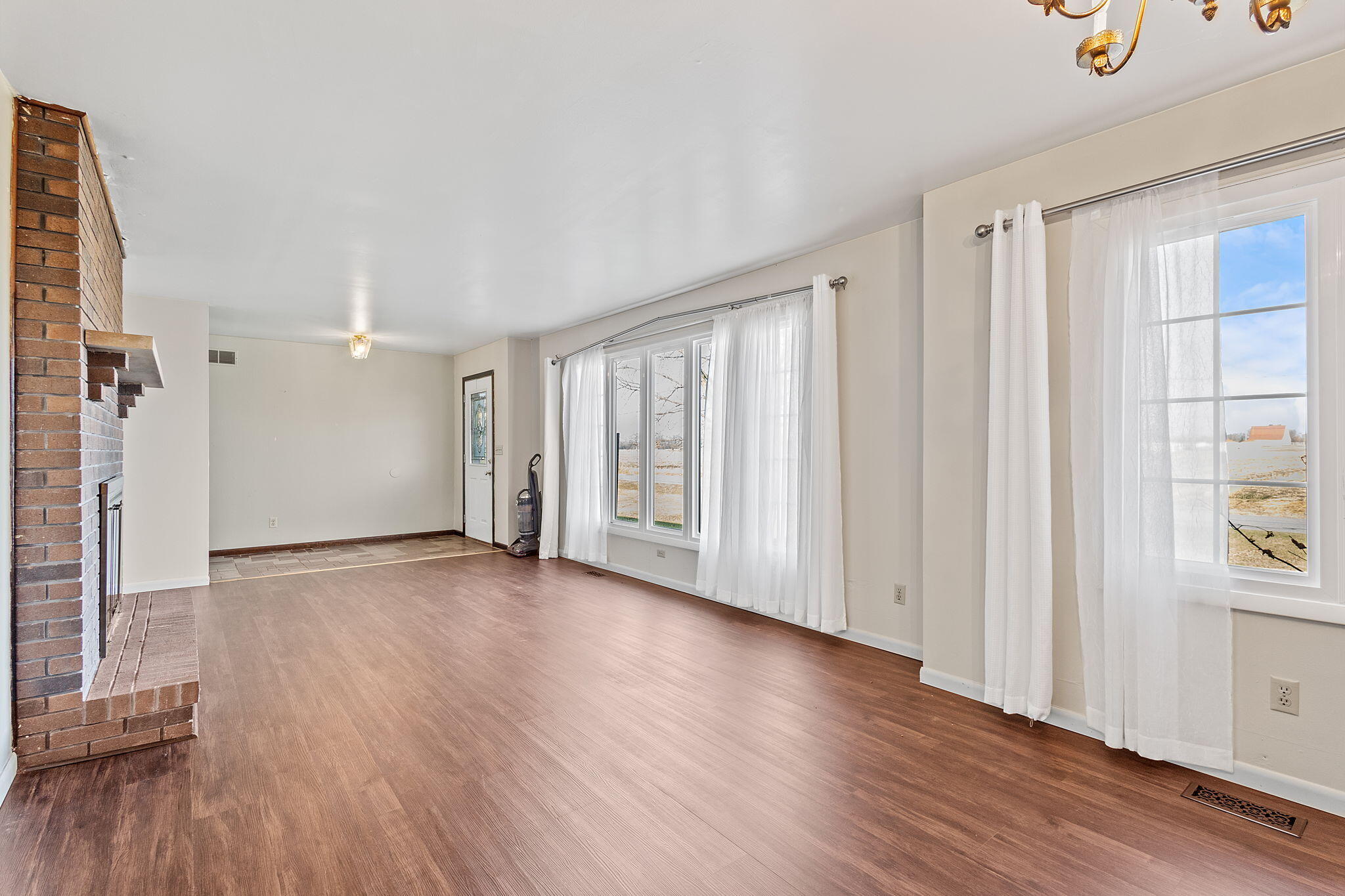 6801 West 1350th Street North Demotte, IN 46310 - Photo 8 of 44 a view of an empty room with wooden floor and a window