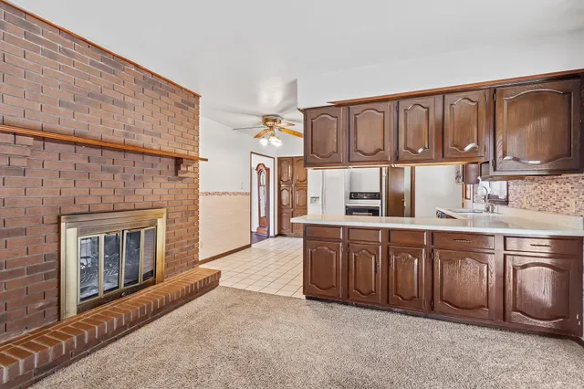 a kitchen with granite countertop a sink cabinets stainless steel appliances and a counter top space