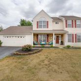a front view of a house with yard and garage