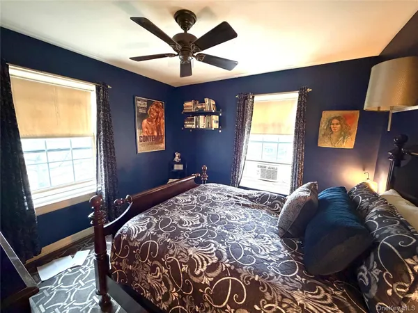 a bed sitting in a bedroom next to a window