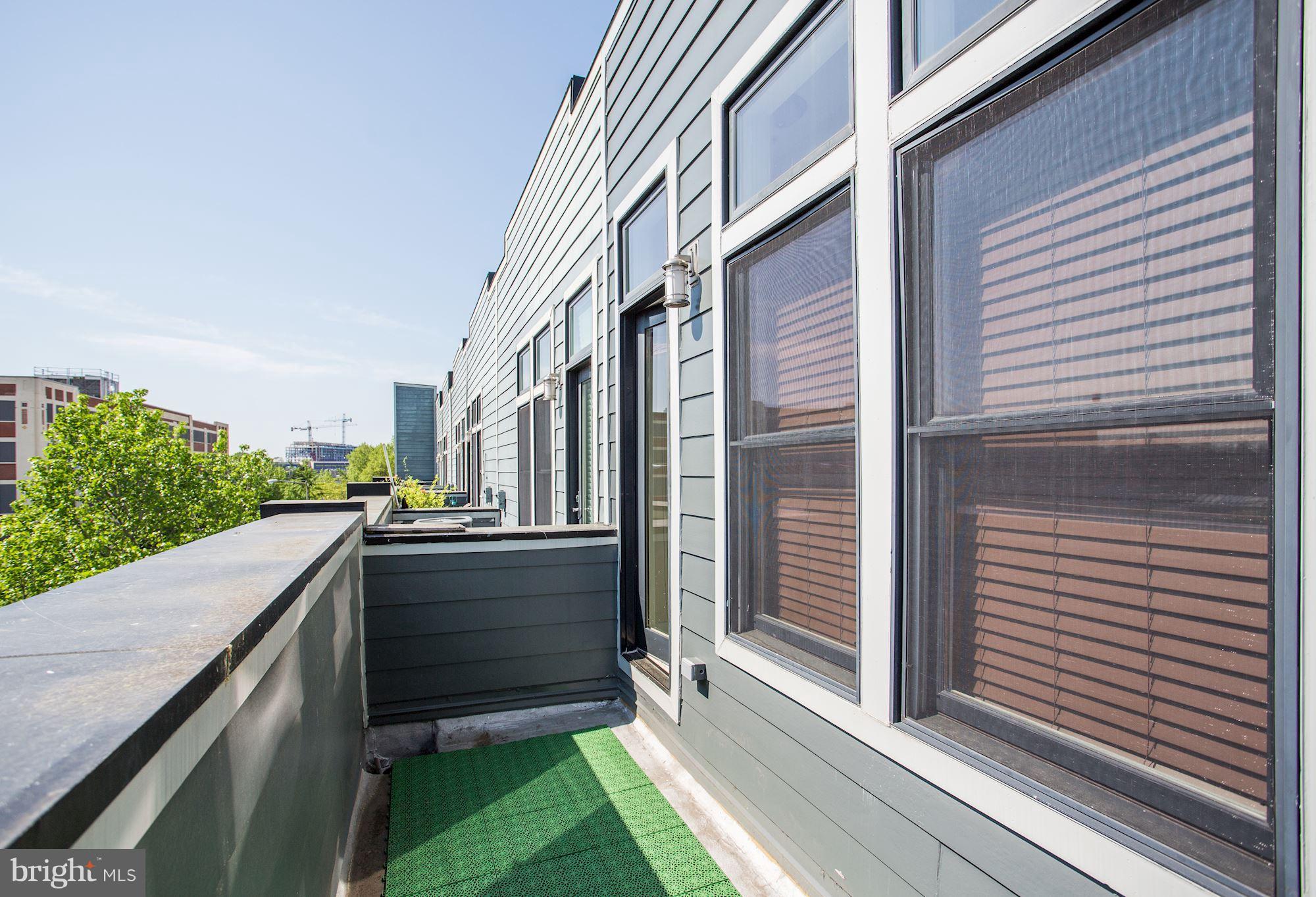 1912 4th Street Northeast, Unit 2 Washington, DC 20002 - Photo 14 of 23 a view of a balcony with wooden floor and fence
