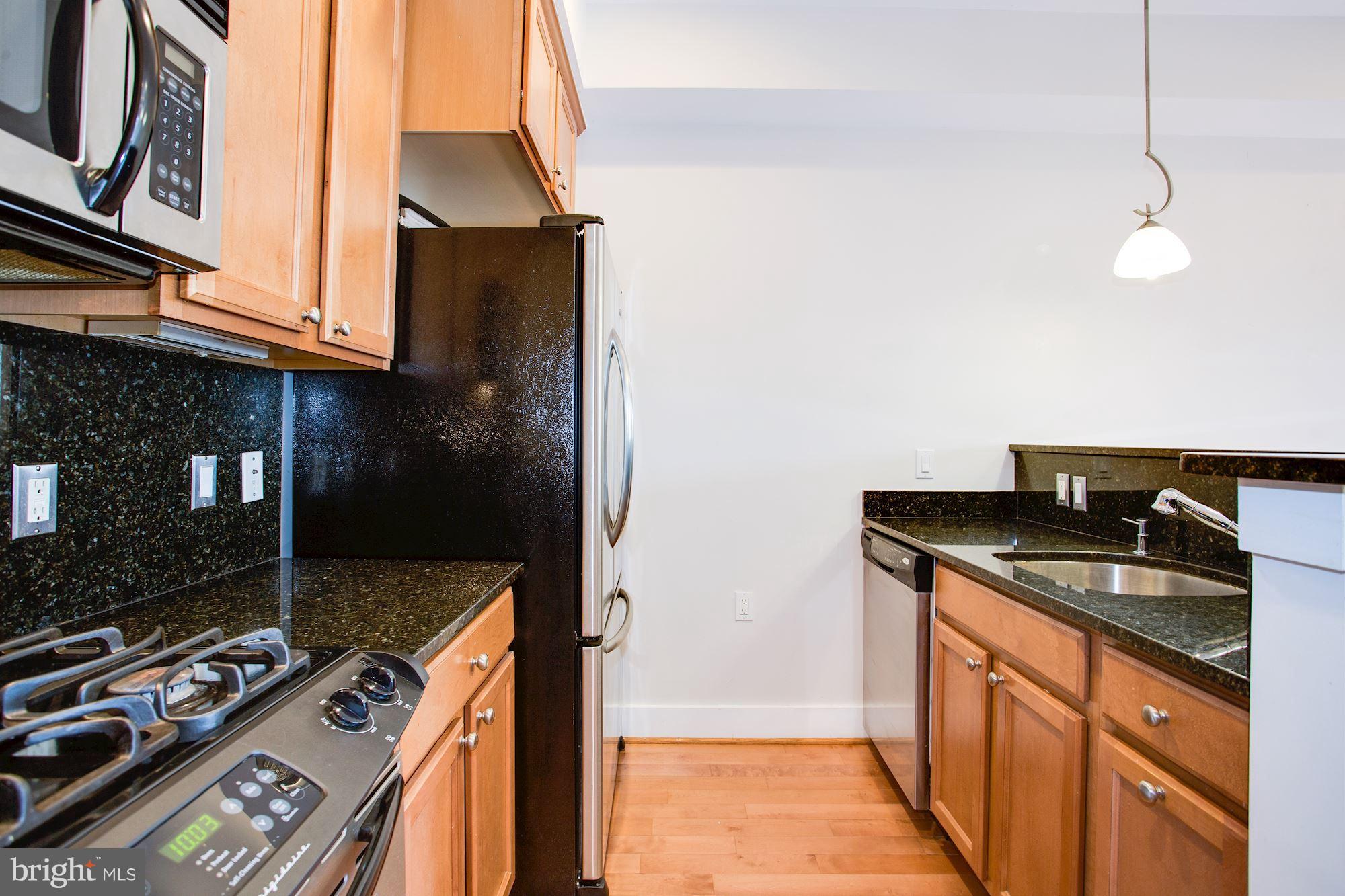 1912 4th Street Northeast, Unit 2 Washington, DC 20002 - Photo 9 of 23 a kitchen with stainless steel appliances granite countertop a sink stove and refrigerator