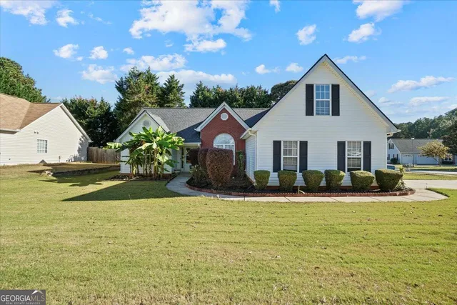 a view of a house with swimming pool and sitting area